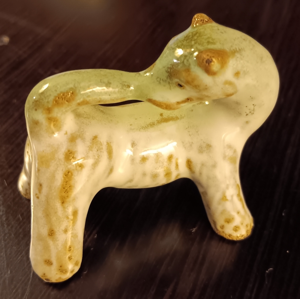 CERAMIC DOG BITING TAIL FIGURE